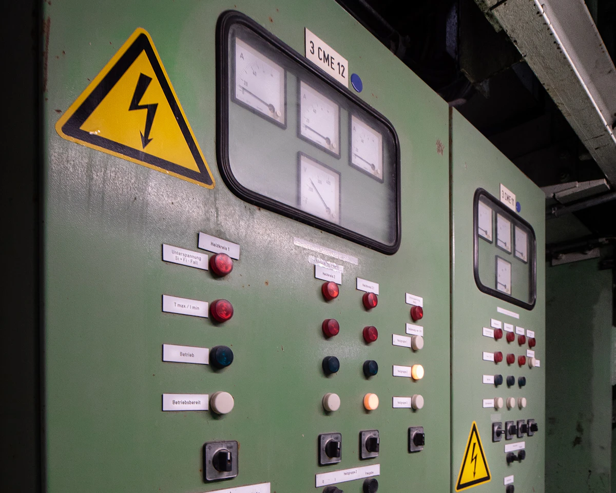 Industrial control panel with analogue meters and indicator lamps.