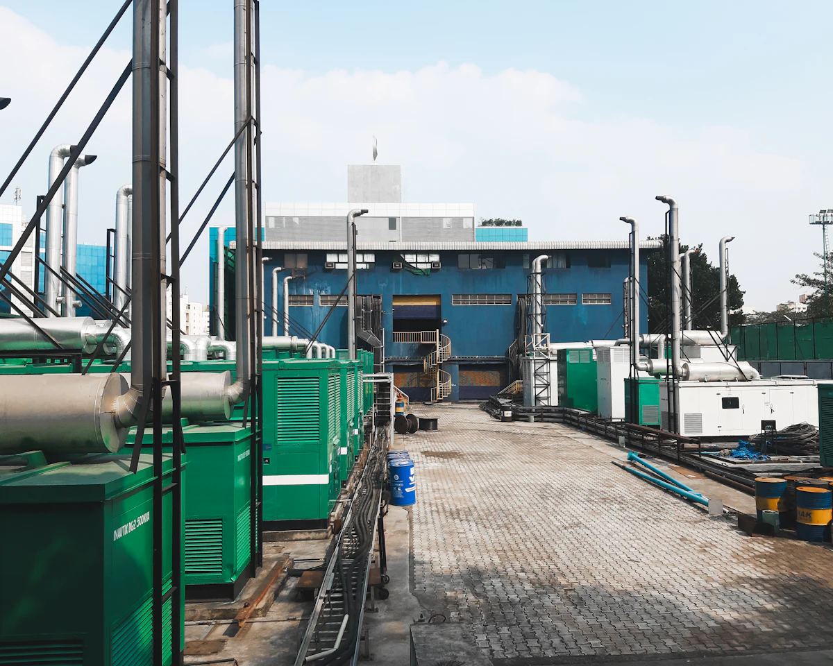 A row of containerised generating units standing on a prepared yard.